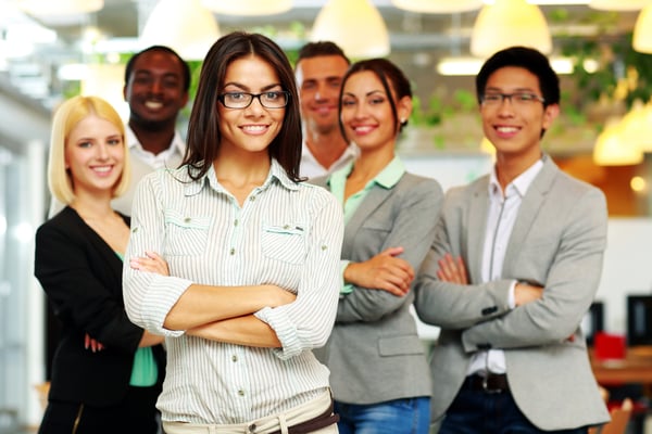 Smiling group of co-workers standing in office